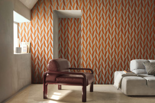 Omexco’s Virginia’s Garden collection brings a striking energy to interiors with this geometric wallpaper in vivid terracotta and soft neutrals. The dynamic leaf-inspired pattern creates movement and rhythm across the walls, transforming the space into a modern retreat where bold design meets natural influence. Styled with clean-lined furniture and soft light, the room balances warmth and sophistication.