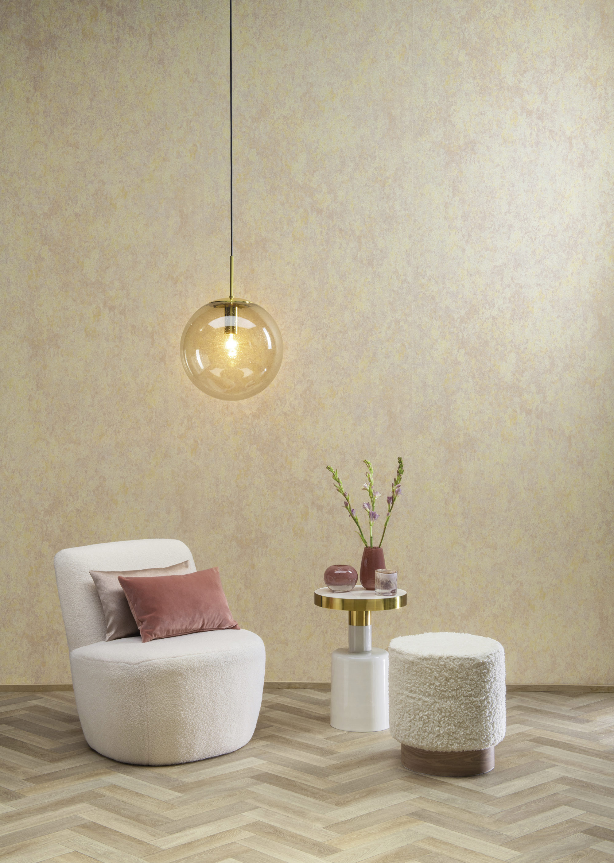 "Morning Dew" design from Omexco's Moonstone collection. Glassbeads are underprinted in powdery boudoir shades. Serene setting with a cosy chair, end table, modern glass pendant light and herringbone wooden floor.